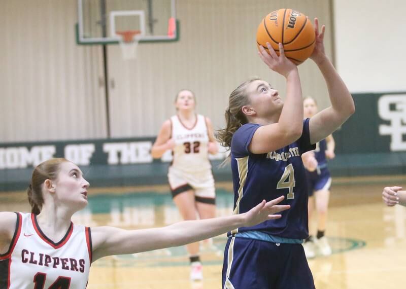 Marquette's Hunter Hopkins eyes the hoop after getting in the lane past Amboy/Ohio's Jullian Anderson during the Class 1A Regional championship on Thursday, Feb. 20, 2025 at St. Bede Academy.