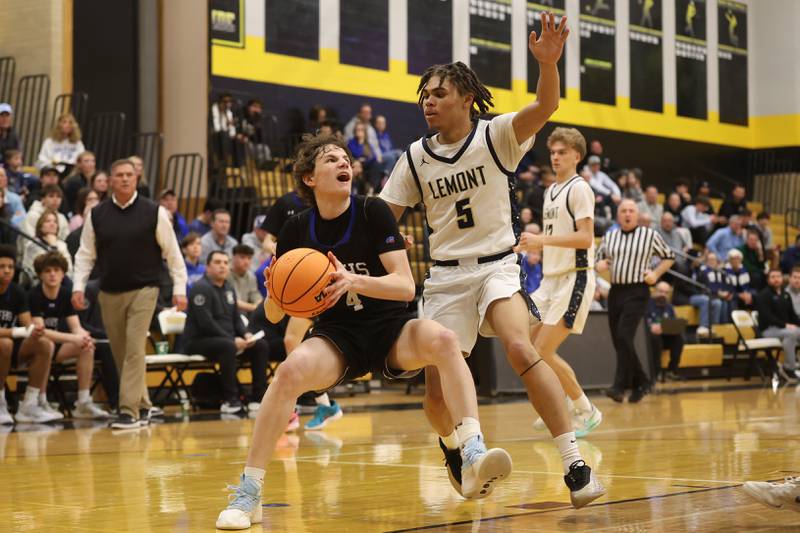 St. Francis’ Johnny Shannon works under the basket against Lemont’s Julian Overton in the Class 3A Hinsdale South Regional semifinal game on Tuesday, March 3, 2026 in Darien.