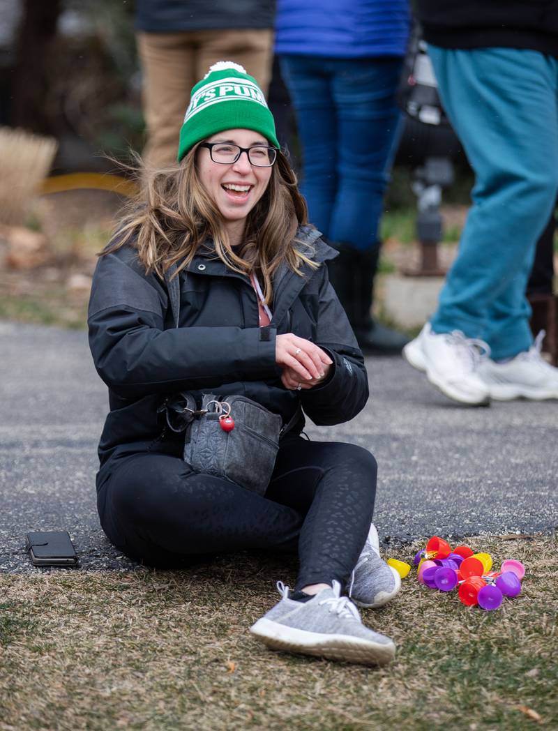 An attendee opens her Easter eggs during the Elmhurst Park District's Adult Easter Egg Hunt at Wilder Park on Saturday, March. 18, 2023.