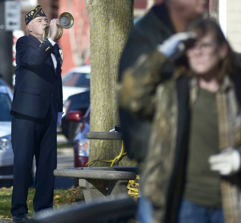 Bob Cokely of American Legion Post 33 plays taps concluding the Veterans Day ceremony Saturday, Nov. 11, 2023, at Washington Square in Ottawa.
