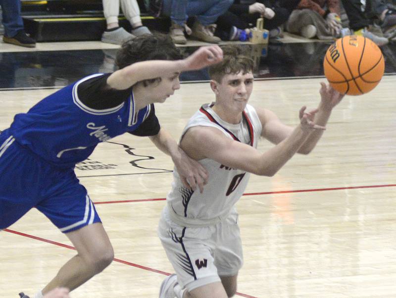 Newark’s Austin Reibel works to stop this pass from Woodland’s Noah Decker in the 3rd period Friday at the Woodland Regional.
