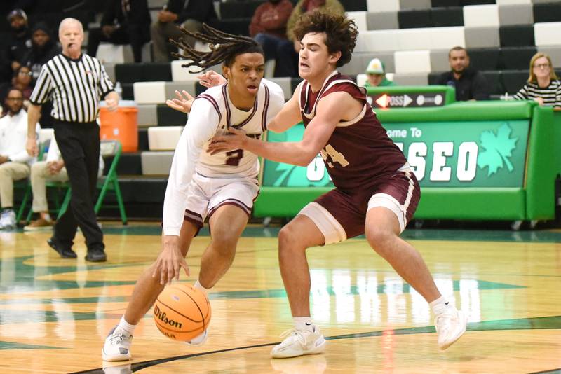 Kankakee's Kenaz Jackson, left, drives past Morris' Austin Delahara during the IHSA Class 3A Geneseo Regional semifinals Thursday, Feb. 26, 2026.