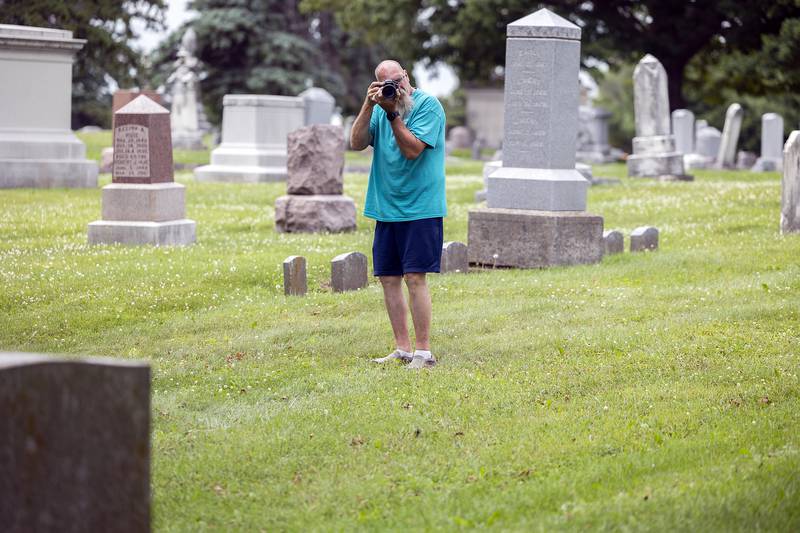 Polo Historical Society member Kevin Smoot snaps a picture Saturday, June 28, 2025, of the trolley used to transport visitors to the Fairmount Cemetery.