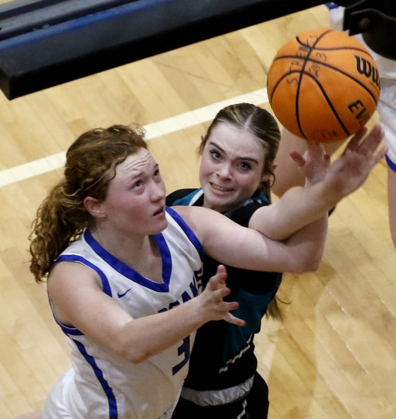 Woodstock's Keira Bogott is fouled by Woodstock North's Adelyn Crabill as Bogott drove to the basket during a Kishwaukee River Conference basketball game on Friday, Jan. 10, 2025, at Woodstock High School.