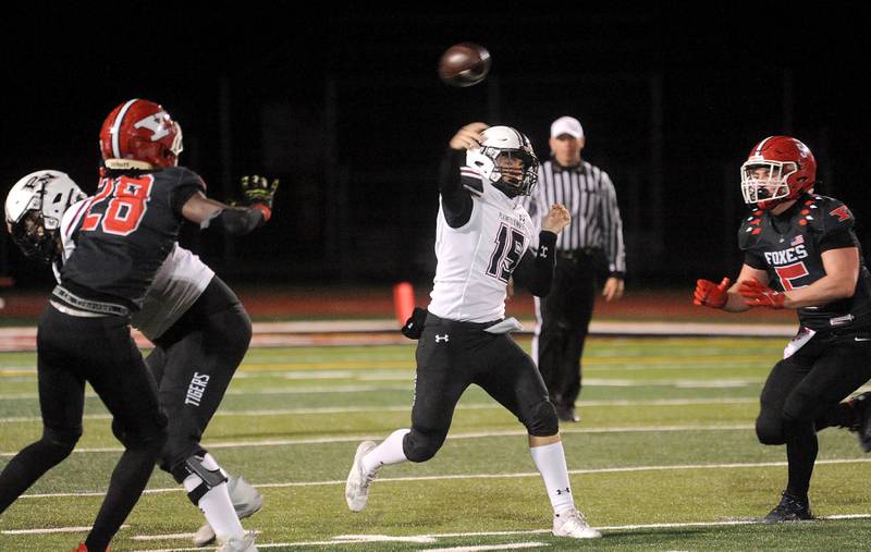 Plainfield North quarterback Nicholas Darwish (15) gets a pass off before Yorkville's Benjamin Alvarez (5) can get to him during a varsity football game at Yorkville High School on Friday, Oct. 20, 2023.