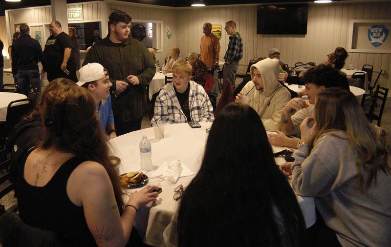 Dylan Wescott visits with friends Saturday, Nov. 22, at his Welcome Home Party at Emerson's Pub in Rock Falls.