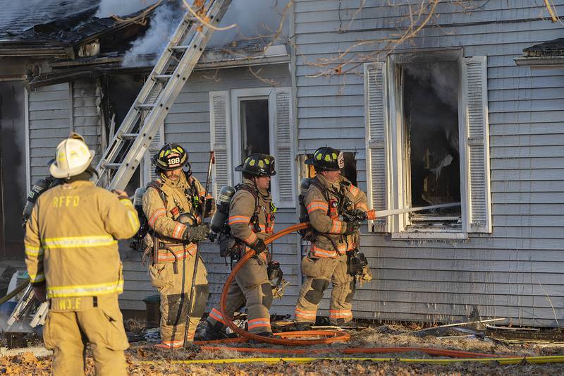 Firefighters pour water onto a fire Sunday, Jan. 19, 2025, at 550 Mill Street in Emerson.
