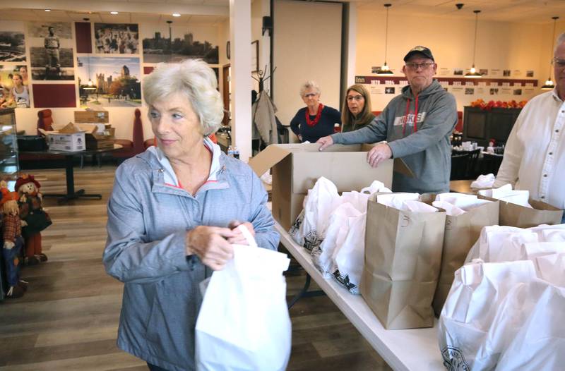 Volunteers hustle free meals out to veterans Friday, Nov. 11, 2022, during a Veterans Day drive-thru dinner event hosted by the DeKalb and Sycamore Elks Clubs at the Lincoln Inn at Faranda's. All veterans received free meals during the event.