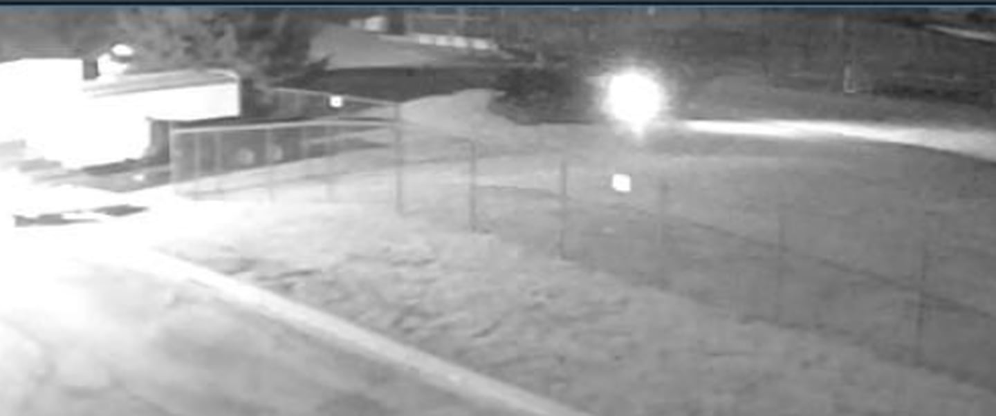 A surveillance photo is seen of the suspect vehicle in the vandalism of Troy Community Consolidated School District 30-C school buses early Monday morning. The catalytic converters were stolen from 30 buses, rendering the buses inoperative. The suspect vehicle is described as a dark colored SUV.