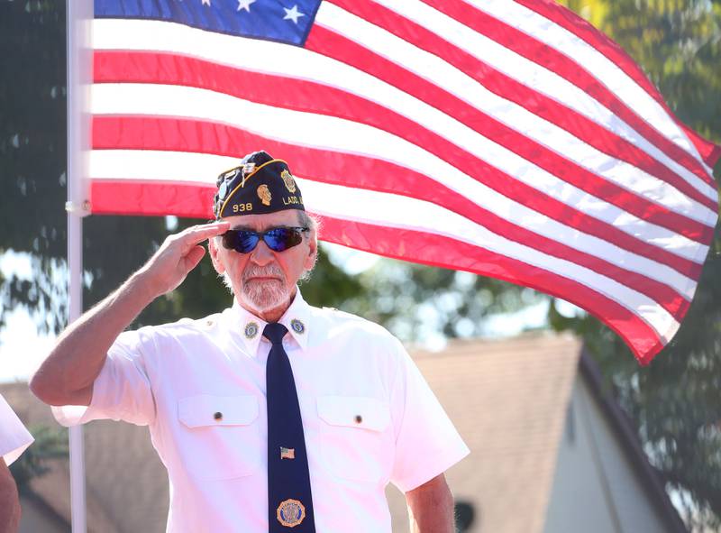 Rich Corsolini commander of the Ladd American Legion Post 938 salutes the American Flag during a 9/11 memorial ceremony on Thursday, Sept. 11, 2025 at the Veterans Park in Ladd.