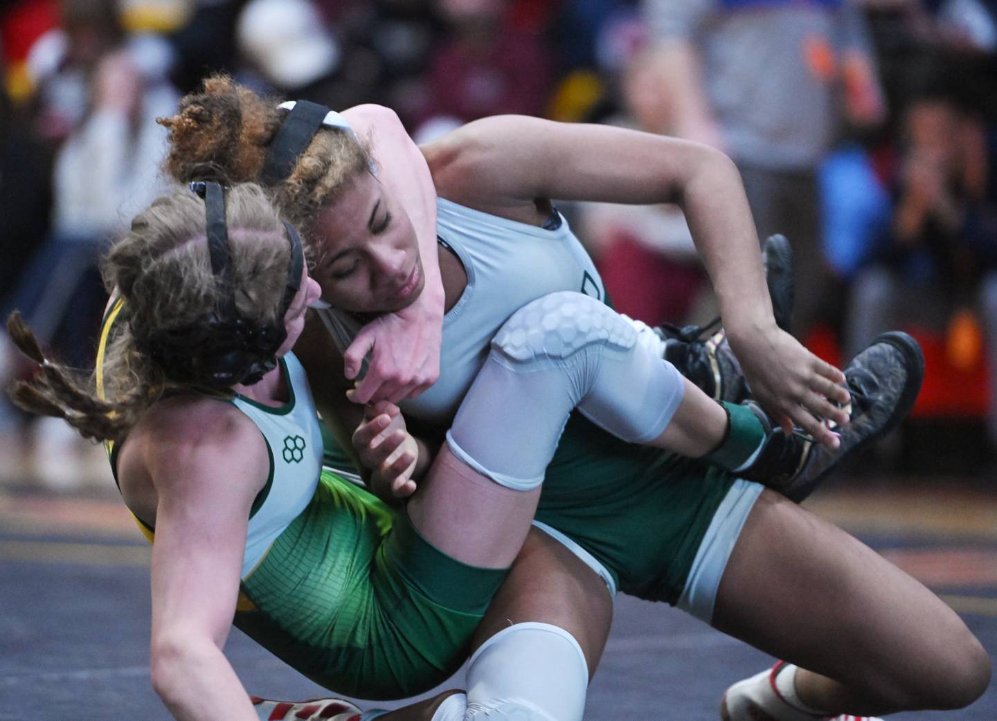 Glenbard West’s Khloe Perez, top, wrestles Crystal Lake South’s Annalee Aarseth in the 110-pound final match during the Schaumburg girls wrestling sectional Saturday.