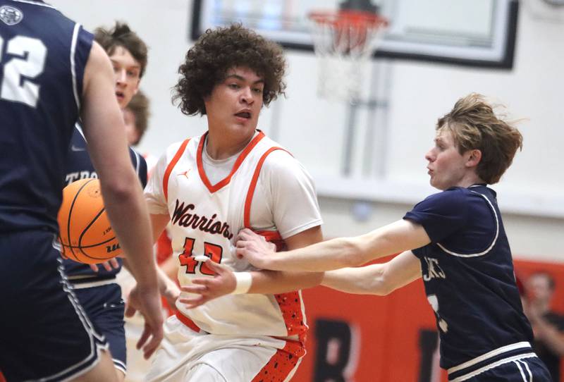 McHenry’s Josiah Kordik moves the ball as Cary-Grove’s Connor Strike defends in varsity boys basketball on Tuesday, Feb. 17, 2026, at McHenry High School in McHenry.