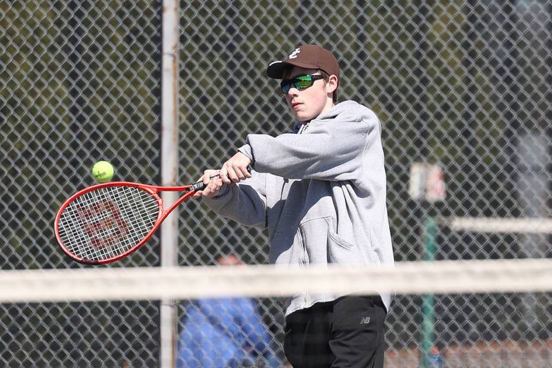 Joliet Catholic’s Thomas Dvorak returns a shot against Joliet Township’s Aaron Strong on Saturday, April 6, 2024 in Joliet.