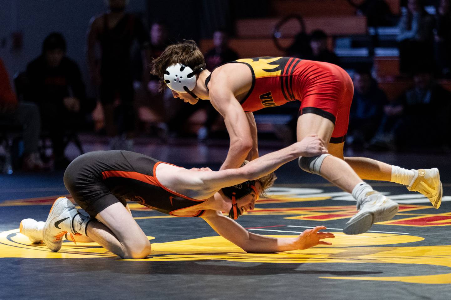Batavia’s Kai Enos (right) avoids a takedown attempt by St. Charles East’s Declan Sons during a varsity wrestling dual at Batavia High School on Friday, Jan. 10, 2025.