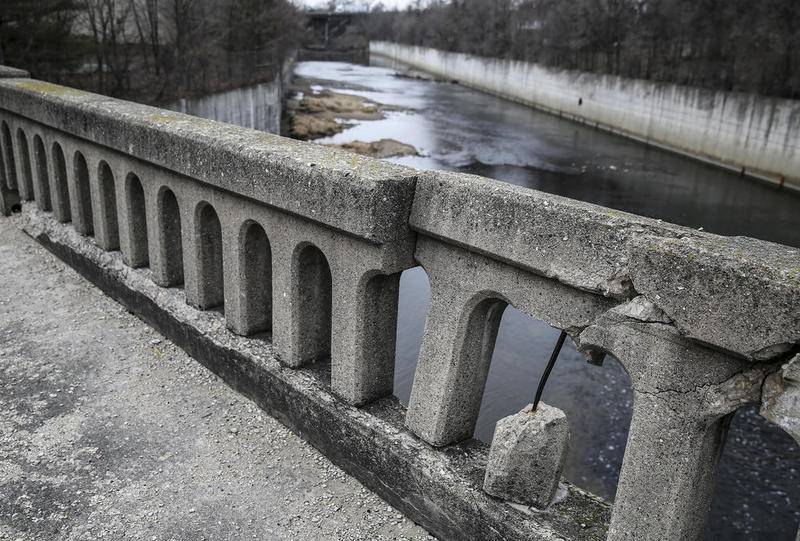 The railing of the Richards Street bridge crumbles Thursday, Dec. 21, 2017, in Joliet, Ill.