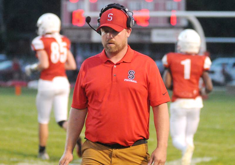 Streator head coach Kyle Tutt walks back to the sideline after talking with players at Doug Dieken Stadium during the 2023 season opener.