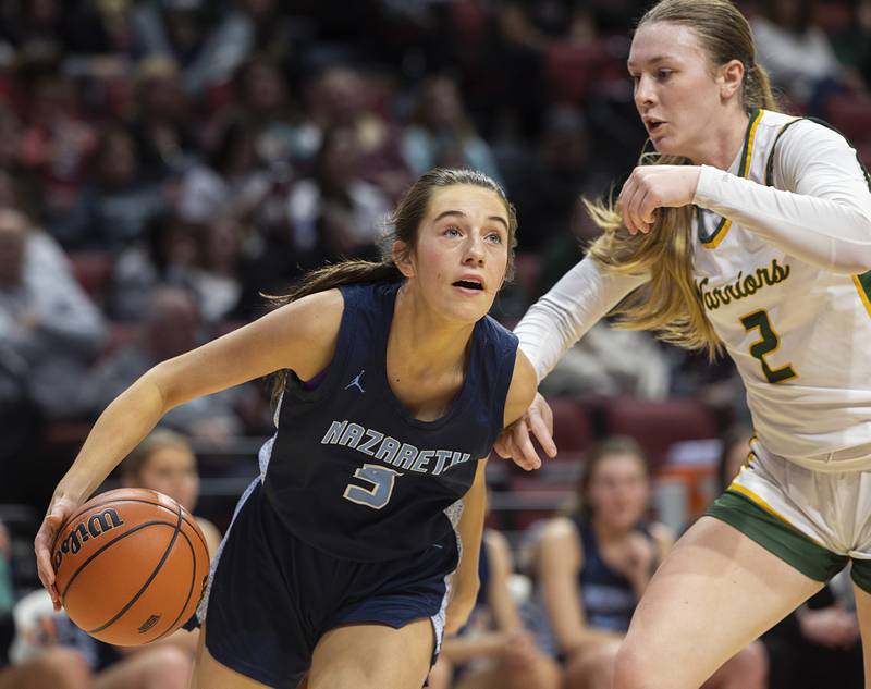 Nazareth Academy’s Lyla Shelton drives against Waubonsie Valley’s Hannah Laub Friday, March 1, 2024 in the girls basketball 4A state semifinal at CEFCU Arena in Normal.