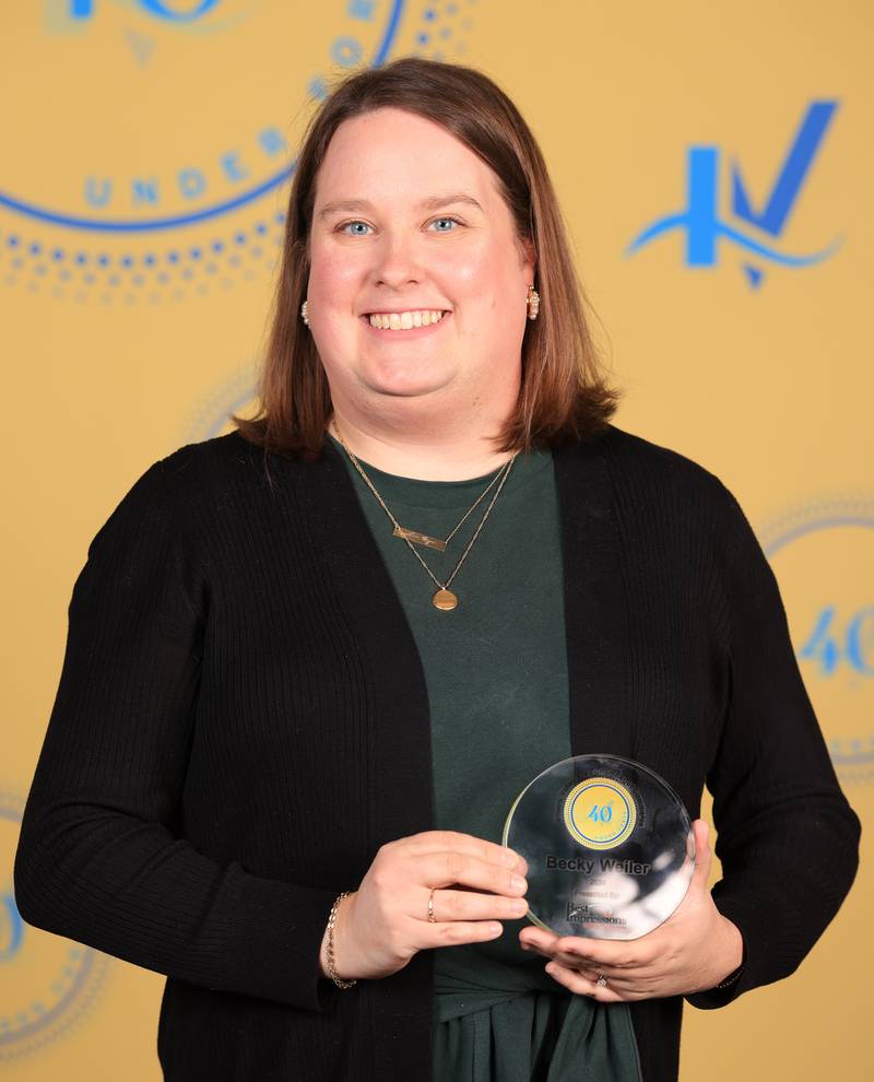 Becky Whiler poses with her 40 Under Forty award during the Illinois Valley Chamber of Commerce Champions of Change Awards Night on Thursday, April 10, 2025 at the Westclox Event Center in Peru.
