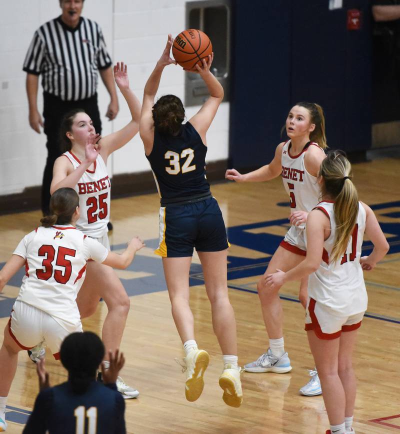 The Benet defense including Samantha Trimberger (25) pressure Neuqua Valley's Tia Poulakidas (32) as she takes a shot during Tuesday’s IHSA Class 4A regional semifinal girls basketball game in Aurora.