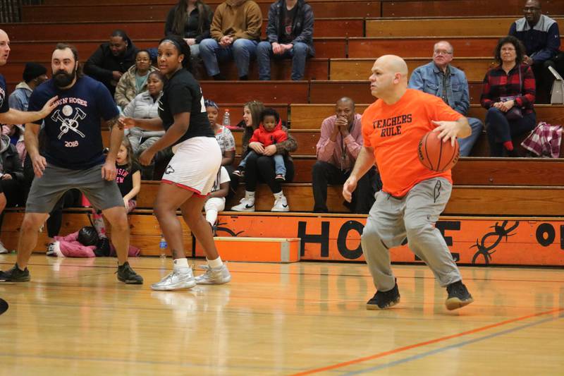 Gregory Blasky (right) takes to the hardwood Monday, Dec. 5 in the Toys for Tots community basketball game.