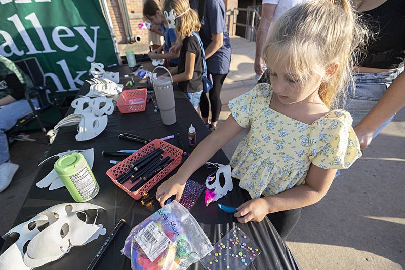 Evelyn Kahn, 6, of Dixon picks just the right adornments for her handmade mask Saturday, Aug. 10, 2024 at Dixon’s Venetian Night. Sauk Valley Bank sponsored a mask-making booth for all budding artists.