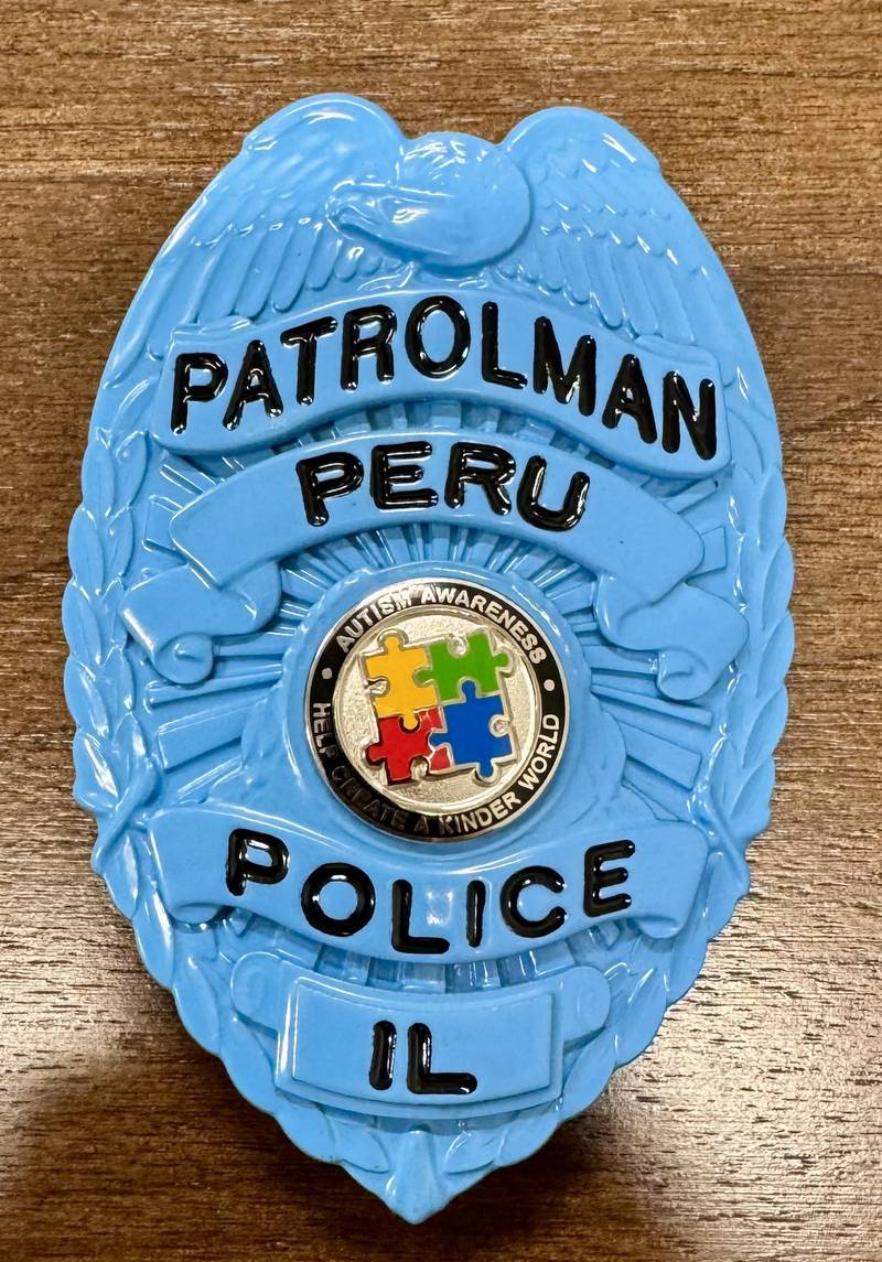 The blue badge all Peru Police officers will be wearing in April 2025 in honor of Autism Awareness month.