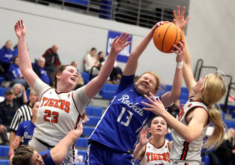Burlington Central’s Maggie Shell, center, snags a rebound as Crystal Lake Central’s Leah Spychala, left, and Ruby Macke close in during IHSA Class 3A Regional Title Game girls basketball action on Thursday, Feb. 20, 2025, at  Central High School in Burlington.
