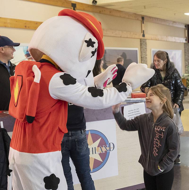 Payton Simmons, 7, greets Marshal the fire safety dog Saturday, Jan. 11, 2025, at the mall.