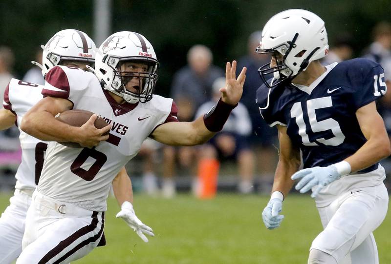 Prairie Ridge's Luke Vanderwiel tries to get away from the pursuit of Cary-Grove's Jason Ritter Jr. during a Fox Valley Conference football game on Friday, Aug. 29, 2025, at Cary-Grove High School in Cary.