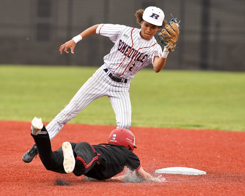 Romeoville's Justin Perez (2) catches the ball and tags out Yorkville's Gabe Sanders (1) during the regional game on Thursday May 29, 2025, held at Yorkville High School.
