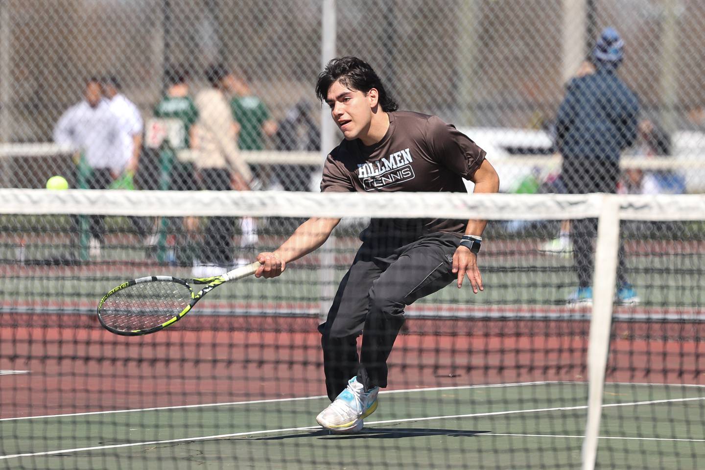 Joliet Catholic’s Andy Munoz runs down the ball against Joliet Township’s Paul Coffey on Saturday, April 6, 2024 in Joliet.