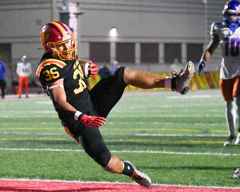 Batavia's Preston Brummel (36) falls into the endzone for a touchdown during the first round of playoffs on Friday Oct. 31, 2025,  while taking on Hoffman Estate held at Batavia High School.