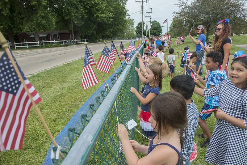 Kids and faculty at the Sterling-Rock Falls Child Care show off their spirit Friday, July 1, 2022 by dressing in red, white and blue and waving flags and noise makers at passing cars. Parents and grandparents were anxious to drive by and honk to their loved ones for this fun event.