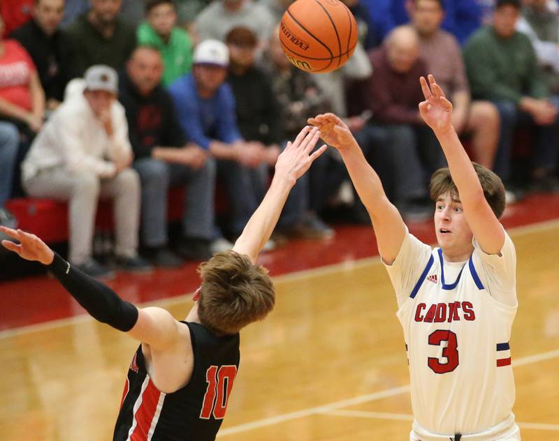 Marmion's Collin Wainscott shoots a three point basket over Metamora's Tyler Mason during the Class 3A Super-Sectional on Monday, March 6, 2023 at Ottawa High School.