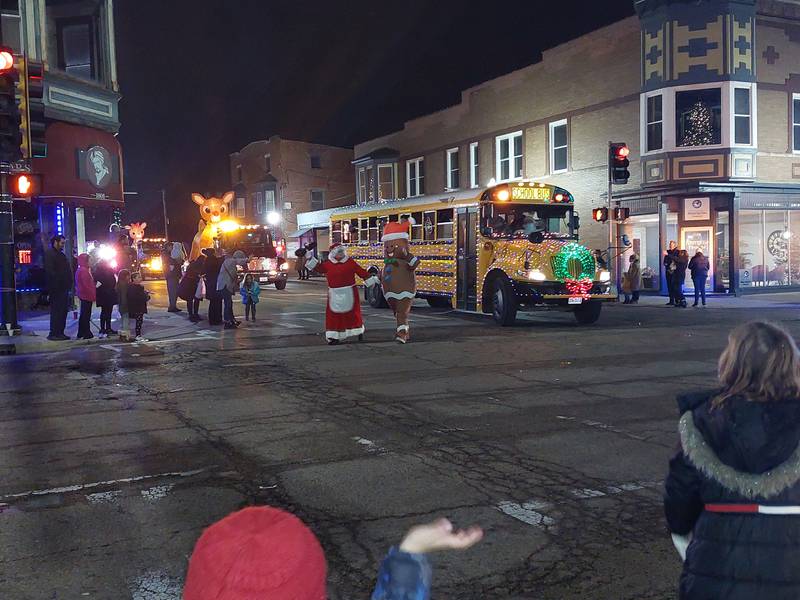 Mrs. Claus is escorted by a gingerbread man Saturday, Dec. 2, 2023, during the Lighted Christmas Parade in Peru.
