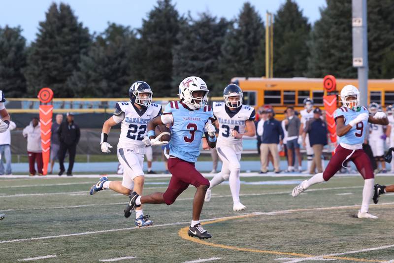 Kankakee's Cedric Terrell breaks away from Nazareth defenders to run for a touchdown in the first quarter during Kankakee's 33-12 loss to Nazareth on Friday, Aug. 29, 2025.