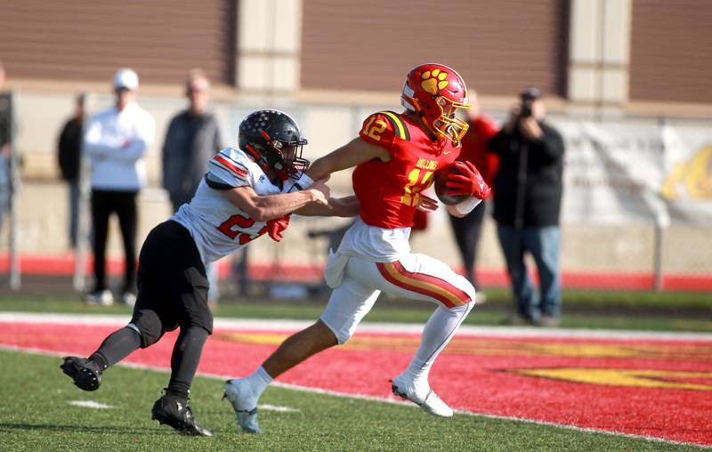 Batavia’s Luke Alwin runs the ball in for a touchdown as he’s trailed by Lincoln-Way Central’s Ryan Mackowiak during the Class 7A second round playoff game in Batavia on Saturday, Nov. 4, 2023.