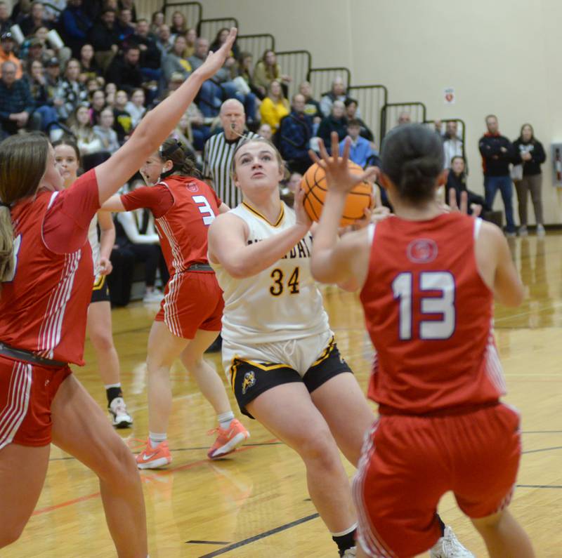 Riverdale's Brooklyn Peterson (34) looks to shoot as Oregon's Sarah Eckhardt (13) and Aniyah Sarver (23) defend at the 2A Erie-Prophetstown Regional on Thursday, Feb. 20, 2025.