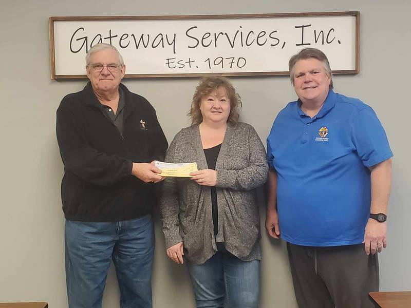 Jeff Peacock (right) and Deacon John Murphy of the Father Edward Farrell Knights of Columbus Council 5591 in Princeton presented checks totaling $2,100 to Tracy Wright (middle), CEO of Gateway Services.