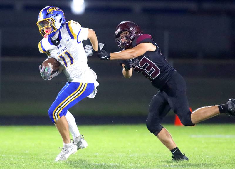 Johnsburg’s Ryan Franze eludes Marengo’s Michael Meyer in varsity football at Rod Poppe Field on the campus of Marengo High School in Marengo on Friday, Oct. 3, 2025.