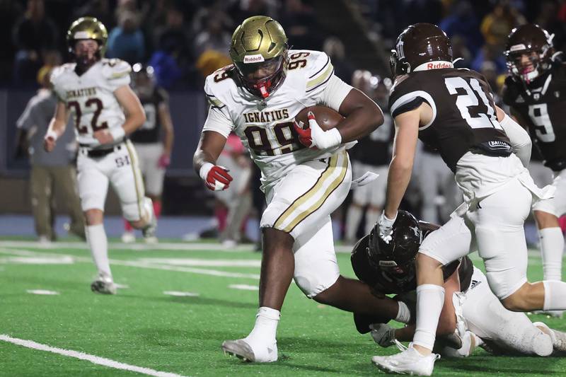 St. Ignatius’ 240 pound fullback Justin Scott sheds a tackle on a run against Joliet Catholic on Friday, Oct. 20 in Joliet.