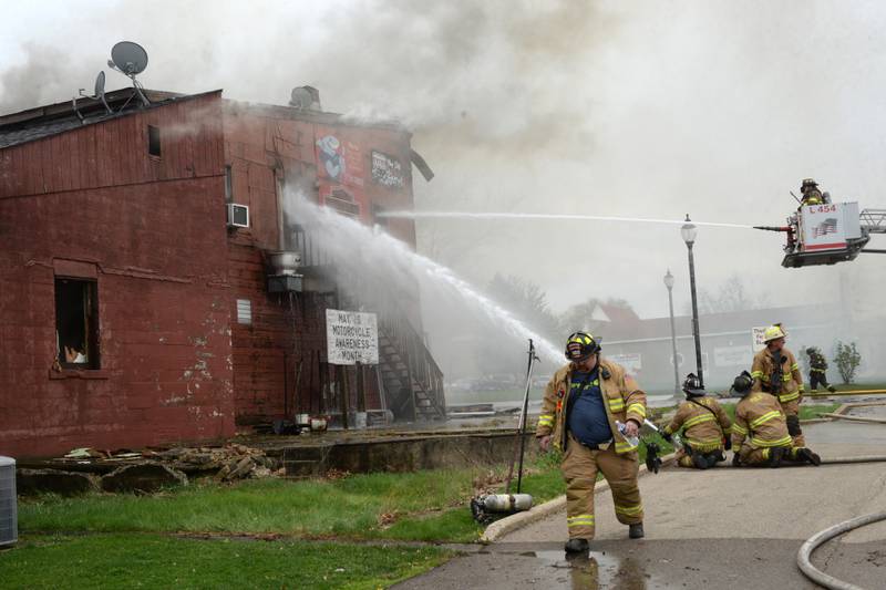 Firefighters from several departments responded to a structure fire at the corner of Main Street and Wesley Avenue in downtown Mt. Morris on Tuesday, April 16, 2024. The wooden structure housed two apartments and Sharky's Sports Bar. Fire crews battled high winds during the afternoon blaze.