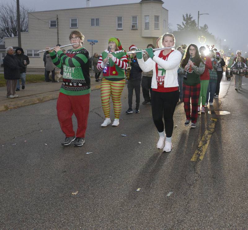The La Salle-Peru High School marching band performed Christmas songs Saturday, Dec. 10, 2022, while marching along Walnut Street during the Winter Parade in Oglesby.