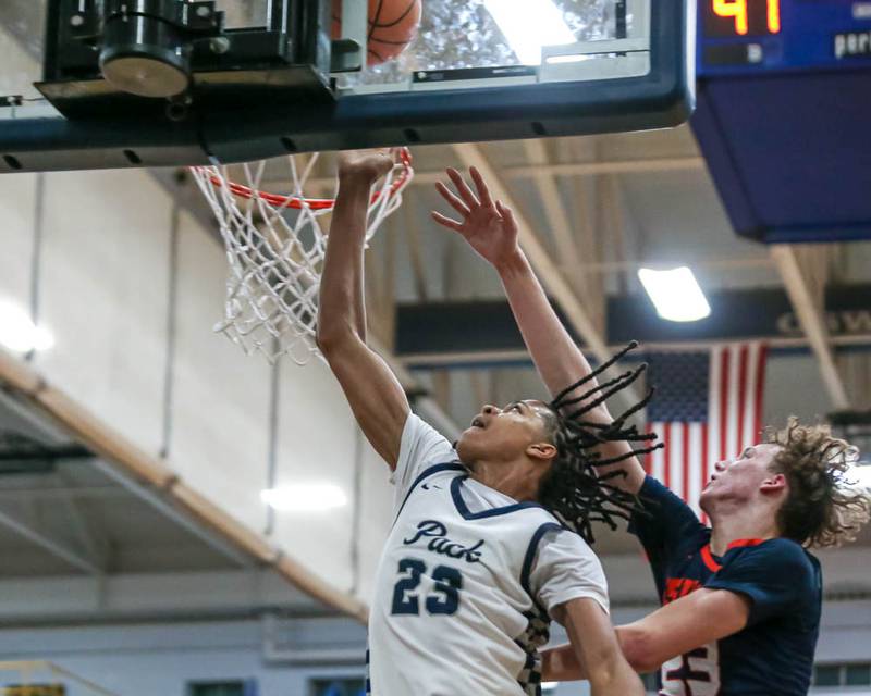 Oswego East's Mason Lockett (23) puts up a shot underneath the basket during their basketball game between Oswego at Oswego East, Feb 13, 2026 in Oswego.