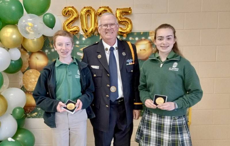 St. Charles American Legion Post 342 member Mike Foulkes (center) presented eighth graders Hank Brightbill (left) and Gianna LaPorte (right) with the American Legion Award at St. Patrick Catholic School on May 9, 2025.