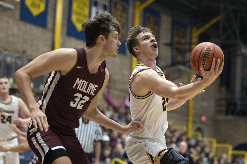 Sterling’s Kael Ryan goes under the basket against Moline Friday, Feb. 10, 2023.
