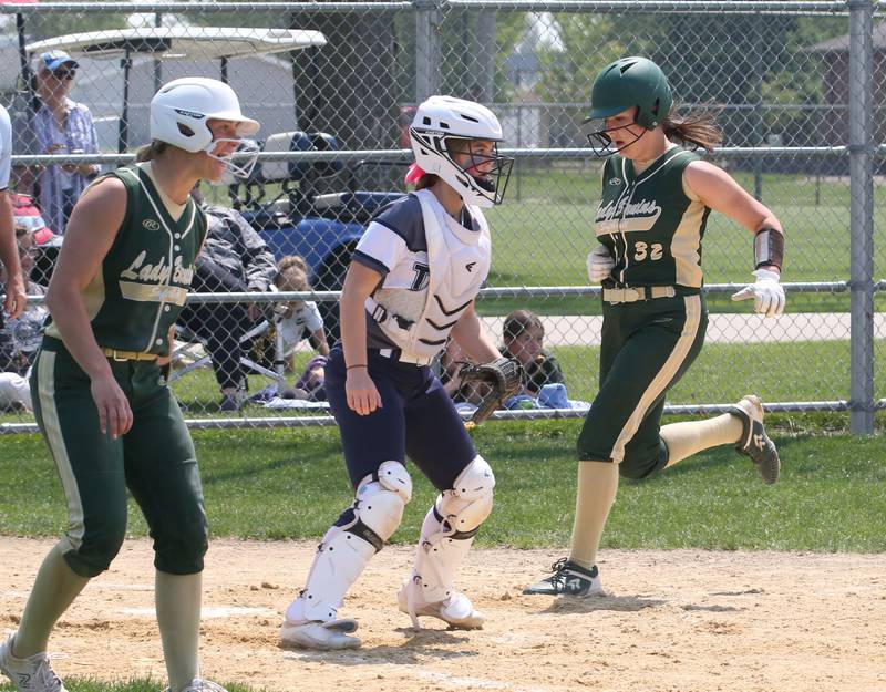 St. Bede's Maddy Dalton crosses home plate as teammate Ella Hermes reacts while playing Annawan/Wethersfield in the Class 1A Regional final game on Saturday, May 20, 2023 in Annawan.