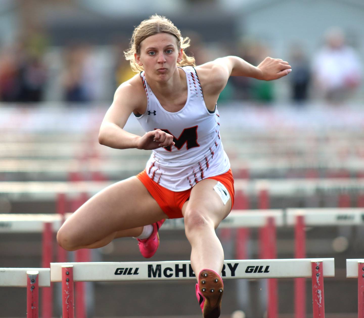 McHenry’s Emma Blanken competes in the 100-meter hurdles during the McHenry County Track and Field Meet at McCracken Field on Thursday, April 24, 2025, in McHenry