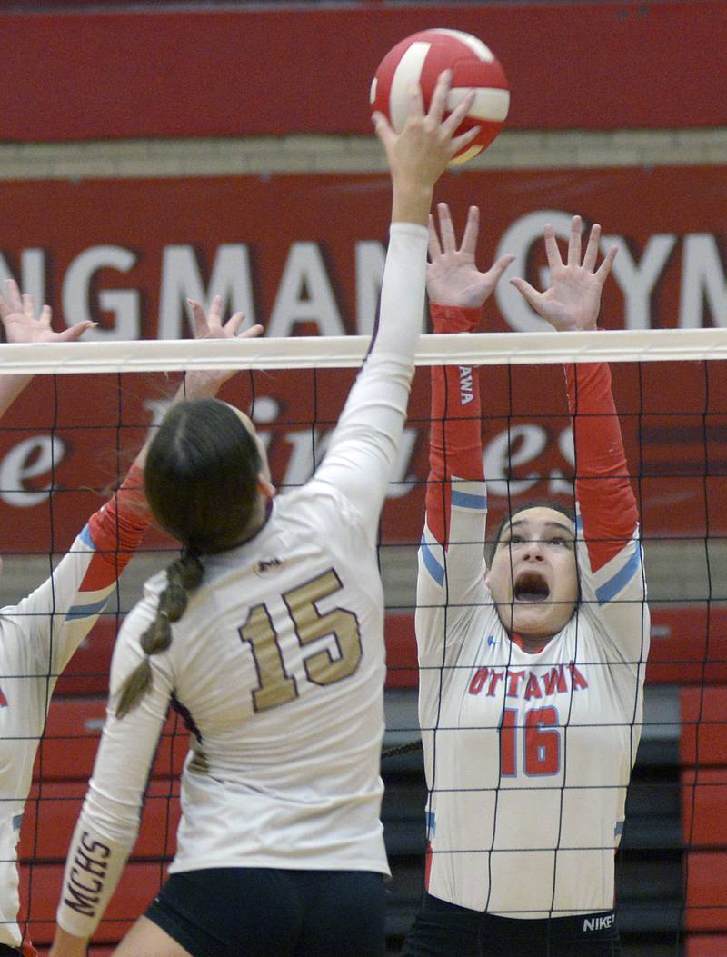 Ottawa’s Addison Duggan reaches to block the ball from Morris’s Lily Hansen  during the 1st set Tuesday at Ottawa.