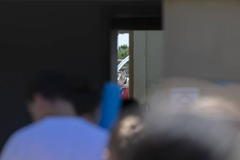 Polo pool lifeguard Gus Mumford, 16, is seen in the pool area as a line of people wait outside the gate Wednesday, June 5, 2024 for the summer opening.